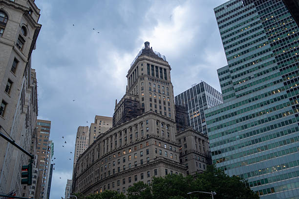 istock Historic architecture meets modern skyscrapers. Downtown financial district under cloudy sky. 2222531916