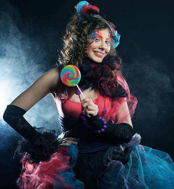 istock Girl with with creative make-up holds lollipop. 2222533747
