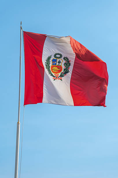 istock Peruvian flag waving in the wind against a clear blue sky 2222535543