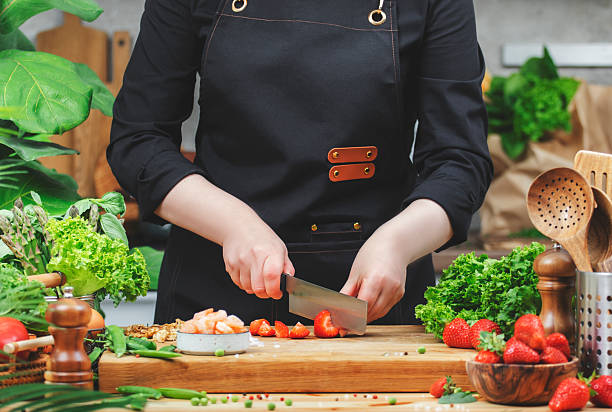 istock Chef prepares fresh vegetables and strawberries in a modern kitchen during daytime cooking session 2222536057