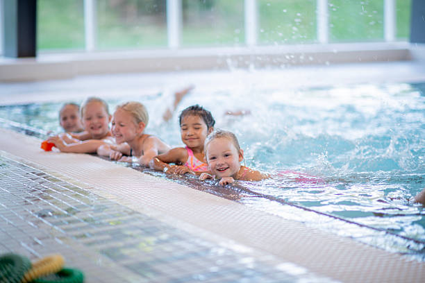 istock Children Having Fun During Swim Lessons at Indoor Pool Facility 2222536189