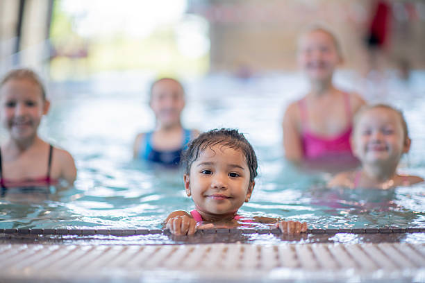 istock Smiling Children Enjoying Group Swim at Indoor Community Pool 2222536227