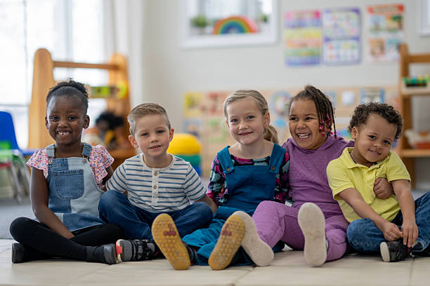 istock Group of Happy Children Sitting Together in a Classroom Setting 2222541509