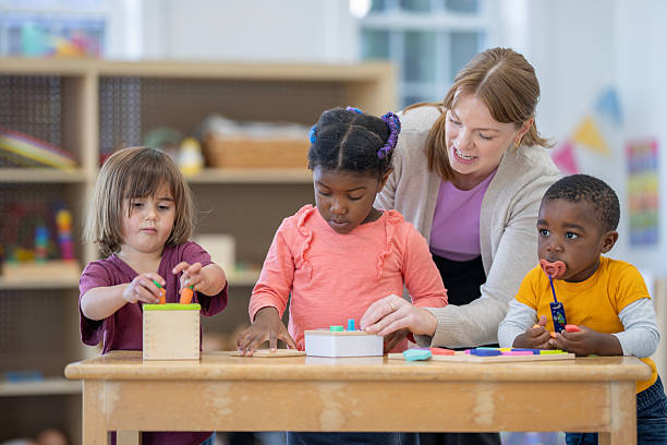 istock Preschool Children Collaborating and Learning with a Caring Teacher in a Classroom 2222542004
