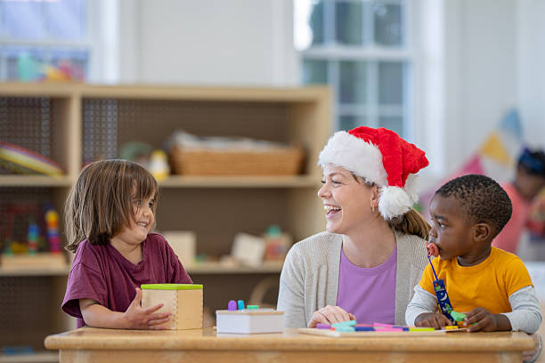 istock Teacher Engaging With Children During Christmas Activities in Classroom 2222542076