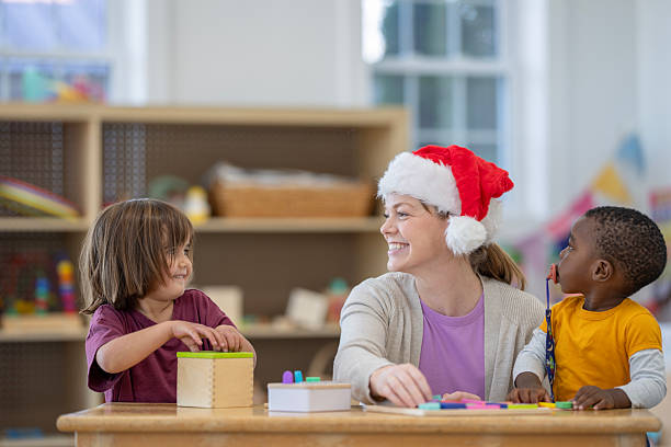 istock Preschool Teacher Engaging With Children in a Festive Classroom Setting 2222542080