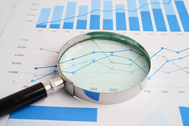 istock Magnifying glass on charts graphs paper. Financial development, Banking Account, Statistics, Investment Analytic research data economy. 2222542344