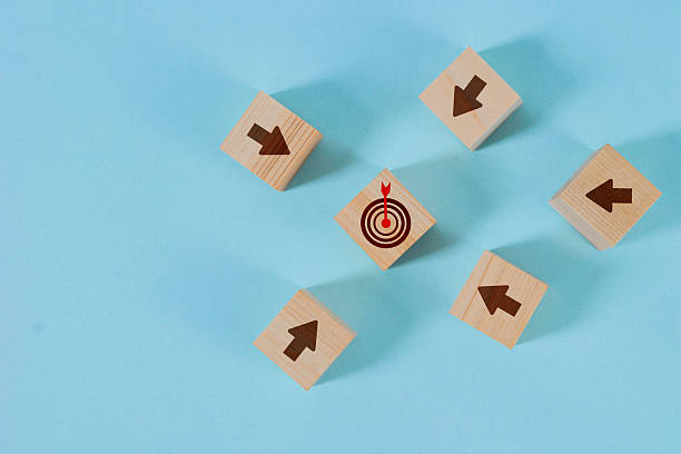 istock Wooden blocks with arrows pointing towards a target block 2222545433