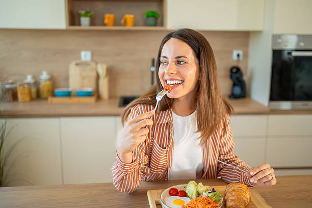 istock Young woman enjoying a healthy breakfast in her modern kitchen 2222546246