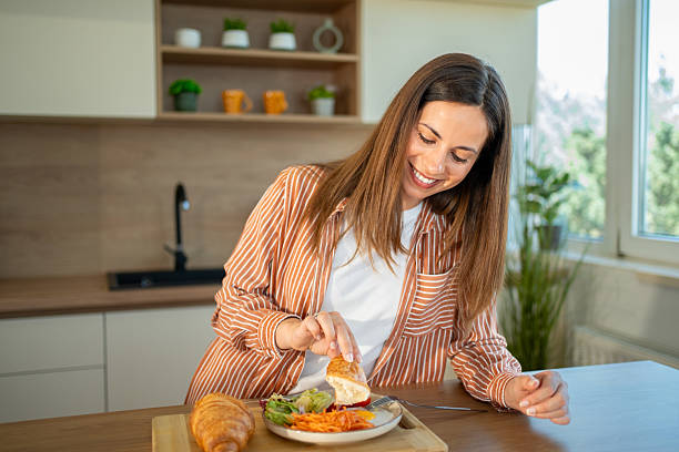 istock Young woman enjoying a healthy breakfast in her modern kitchen 2222546342