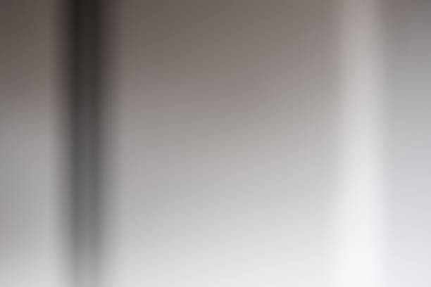 Abstract media of light and shadow on a flat surface.