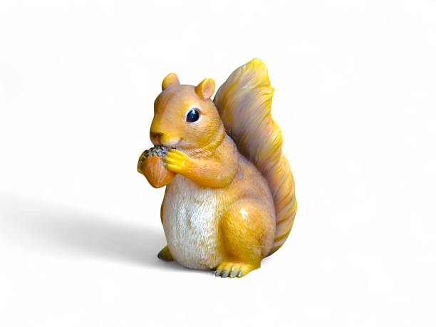 Squirrel Statue with Acorn on white background