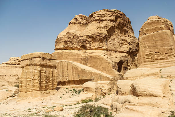 istock Ancient Petra Rock Formations and Carved Structures Under a Clear Sky in Jordan 2222549151