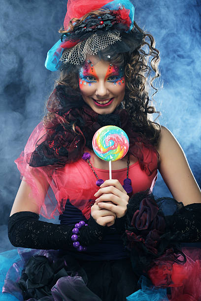 istock woman with creative make-up in doll style with candy. 2222551961