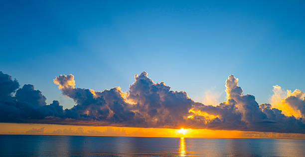 istock Sky at sunset. Sunrise over horizon. Sunlight shining through clouds on sky. Twilight sky with vibrant colors. Peaceful dawn with soft light. Dramatic dusk with glowing clouds. Sunshine in clear sky. 2222552955