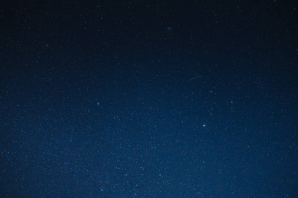 istock Deep blue night sky with bright stars over a quiet rural landscape in thailand 2222554721