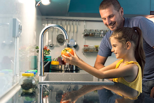istock Child Enjoying Fun Water Play in the Kitchen 2222555468