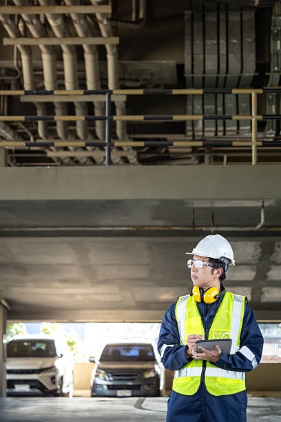 istock Building inspector man in reflective vest using digital tablet working for building maintenance inspection 2222557163