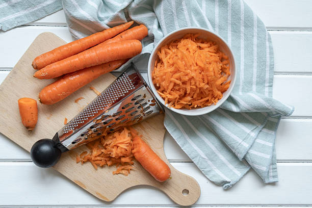 Fresh organic shredded carrots on cutting board