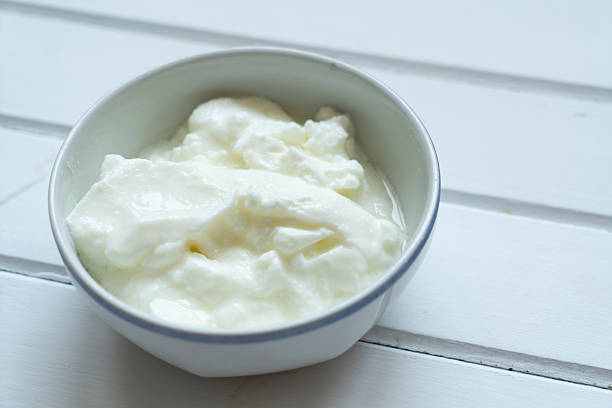 Homemade Yogurt in bowl on white wooden table