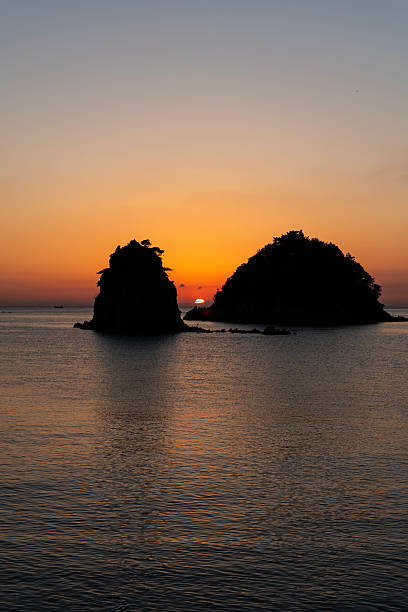 istock sunset over the sea and rocks 2222558237