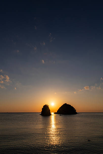 istock sunset over the sea and rocks 2222558262
