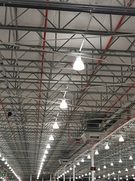istock Large warehouse illuminated with numerous lights and a multitude of spotlights on the ceiling 2222559003