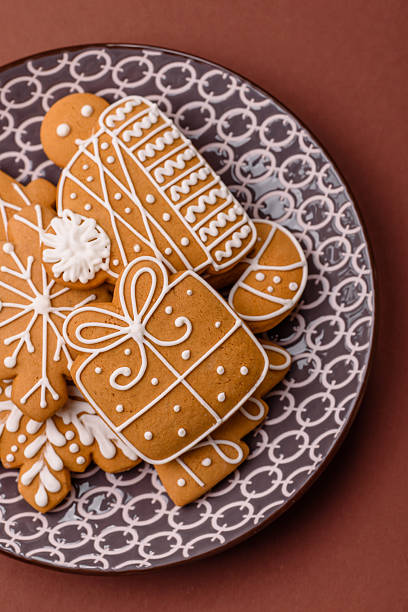 Christmas winter gingerbread, holiday biscuits on monochrome background. New Year gingerbread on the table