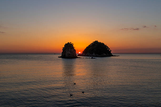 istock sunset over the sea and rocks 2222560337