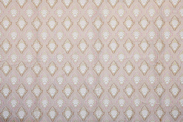 Old wallpaper on the wall. Old wallpaper for texture or background.