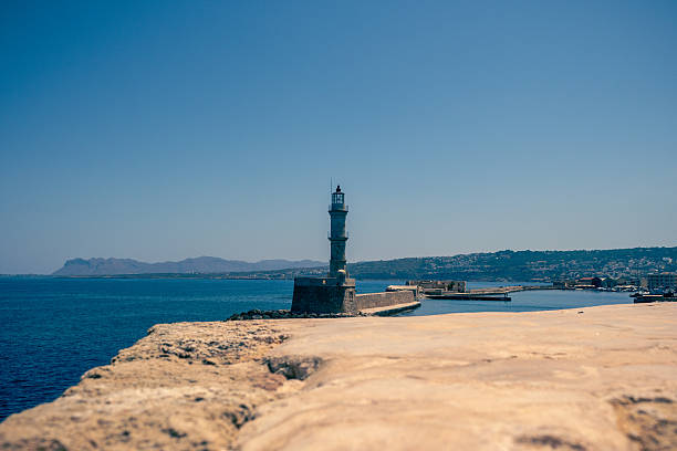 Manavgat harbour entrance and lighthouse with man fishing, bad weather