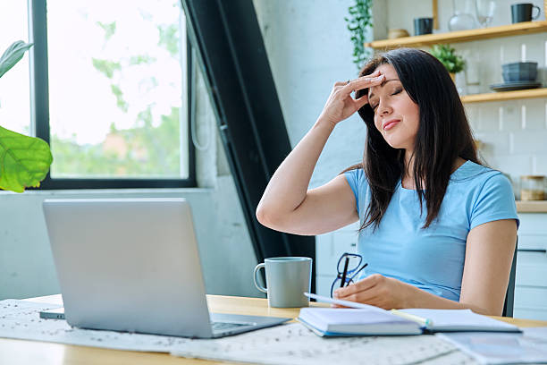 istock Sad stressed woman sitting at home at table with computer 2222562280