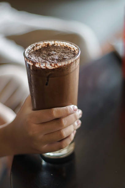 istock Hand holding a glass of ice chocolate drink 2222562607