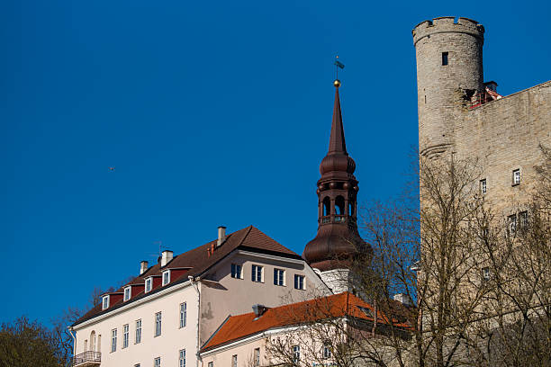 Tallinn, Estonia - May 05 2025: Tallinn’s medieval charm under a clear blue sky. Featuring historic Toompea Castle and a striking church spire.