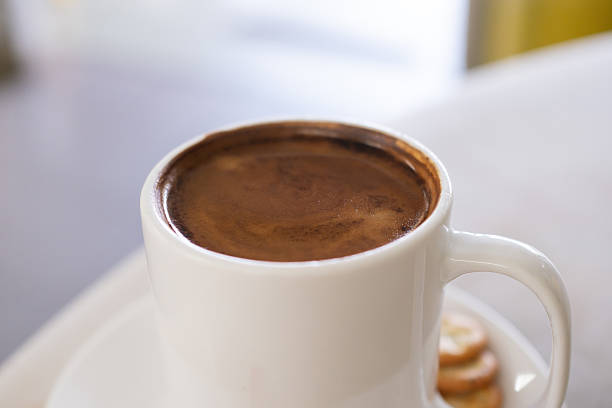 Hot Americano served on mable table.