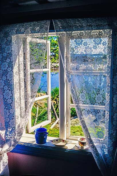 istock Open window in an old cottage with lake view in summer 2222569210