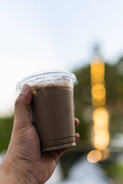 Close up view of ice cocoa drink in plastic glass