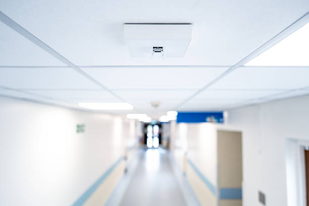 istock Shallow focus of a newly installed multi function smoke detector and emergency lighting seen within a hospital corridor in Britain. 2222575414