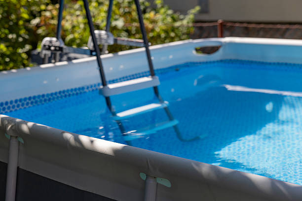 istock Above Ground Pool with Ladder in Sunlit Backyard 2222575704