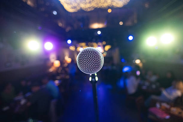 Public performance on stage Microphone on stage against a background of auditorium. Shallow depth of field.