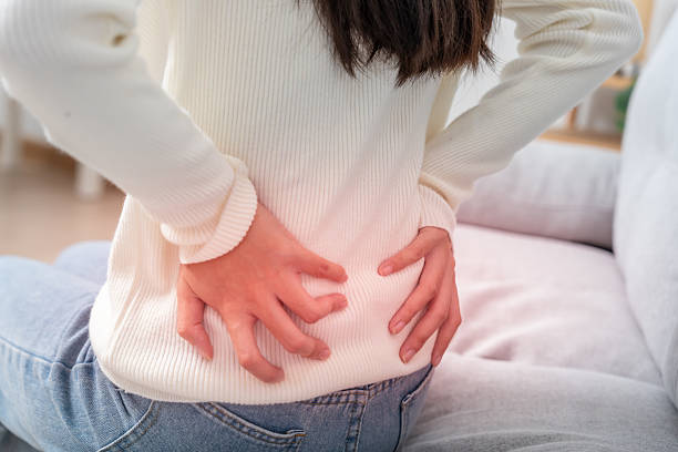 istock woman holding lower back while and suffer from unbearable pain health and problems, chronic back pain, backache in office syndrome, scoliosis, herniated disc, muscle inflammation 2222576225