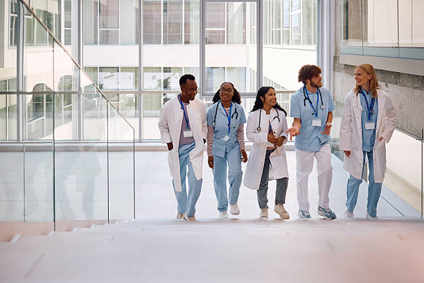 istock Happy medical students talking while walking though university hospital hallway, 2222581640