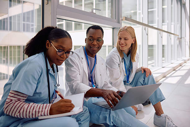 istock Multiracial group of medical students using laptop in university hallway. 2222581714