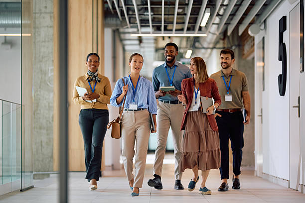 istock Happy diverse business colleagues walking through the office. 2222583417