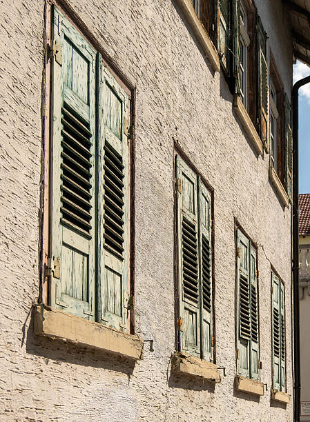 Front of an old house with closed shutters