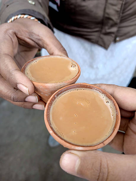 istock Two hands holding warm cups of chai in rustic clay kulhads 2222591487