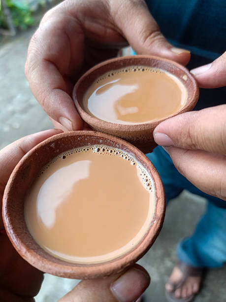 istock Two hands holding warm cups of chai in rustic clay kulhads 2222591495