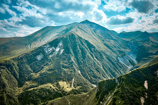 Mountain ranges on a sunny day at Georgia. Sky with clouds adn hills