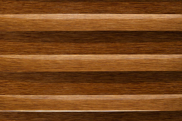 Decorative dark blue striped cushions in the store for a sofa or chair are stacked. Close-up view. Minimalistic background with copy space. Home furniture and Accessories Store