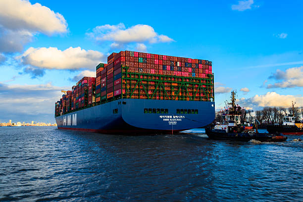 Hamburg, Germany - April 3, 2022: Huge cargo container ship sailing on the Elbe river in Hamburg, Germany